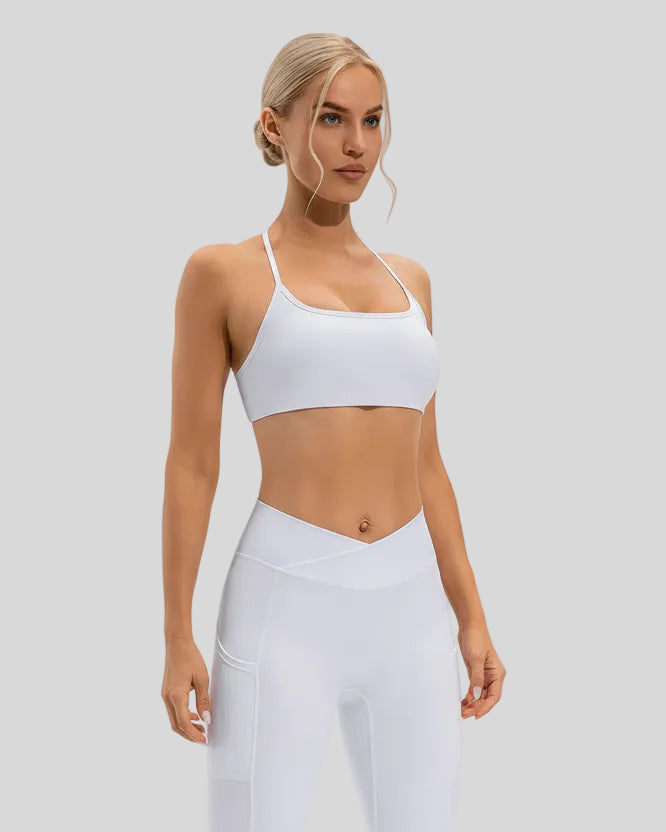 Soft, stretchy performance fabric of LumaForm Crisscross Sports Bra in White - Athlesi