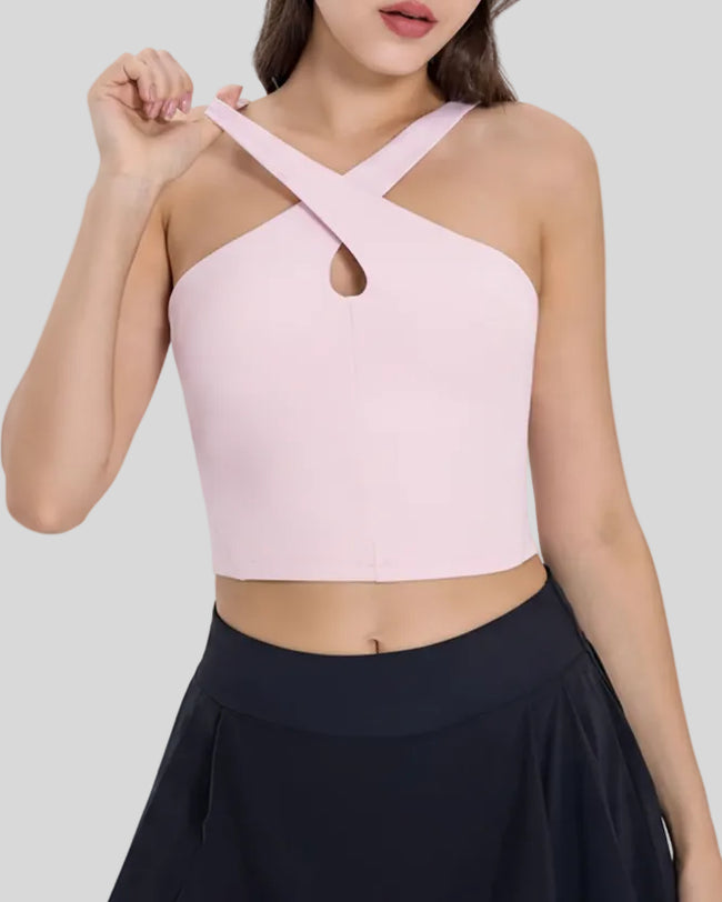 Angled front view of Athlesi LumaForm cross-neck active cami in blush pink