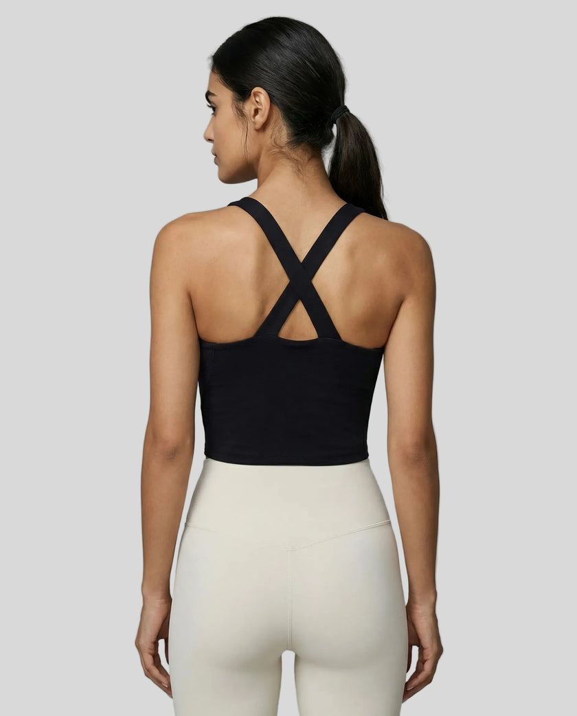 Back view of model wearing a black LumaForm Cross-Neck Cami highlighting crisscross back