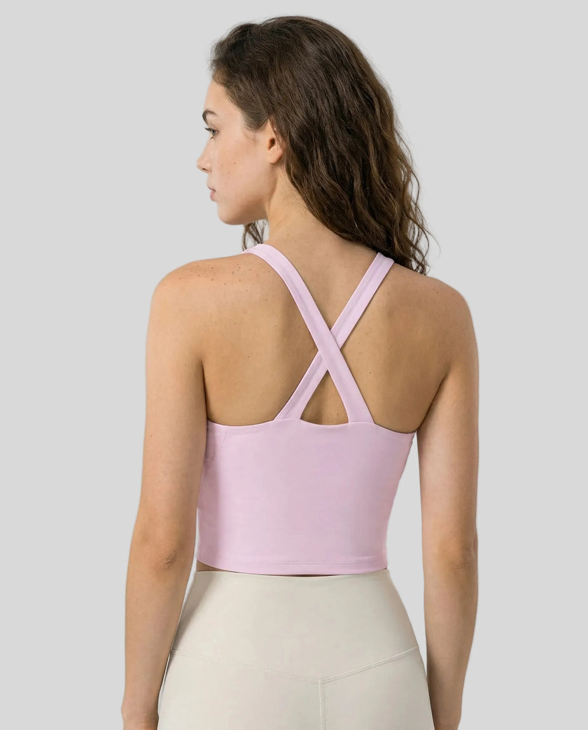 Back view of model wearing a blush pink LumaForm Cross-Neck Cami highlighting crisscross back