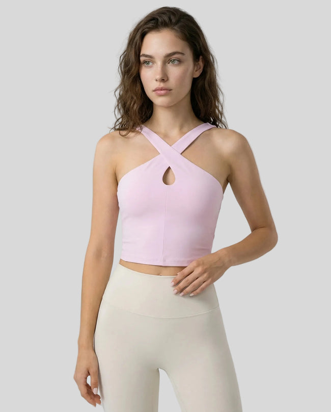 Front view of model wearing a blush pink LumaForm Cross-Neck Cami highlighting silhouette and neck design