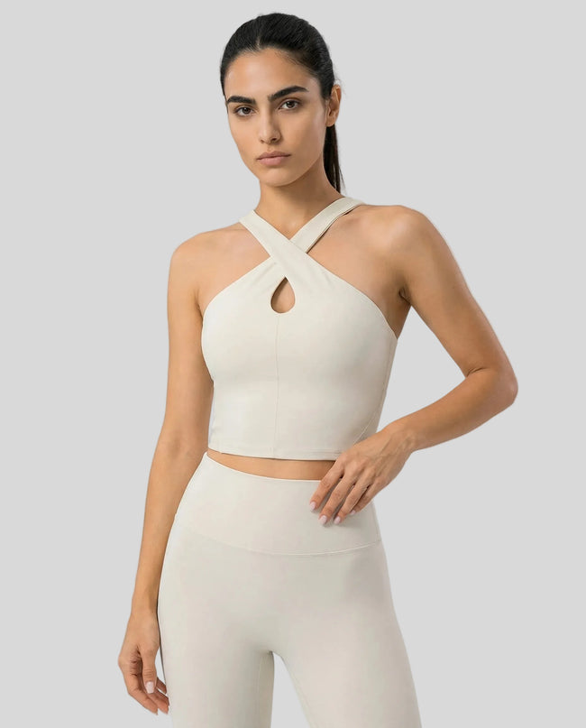 Front view of model wearing a cream LumaForm Cross-Neck Cami highlighting silhouette and neck design