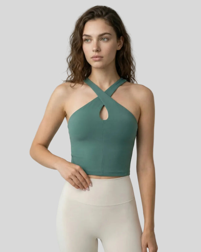 Front view of model wearing a teal LumaForm Cross-Neck Cami highlighting silhouette and neck design