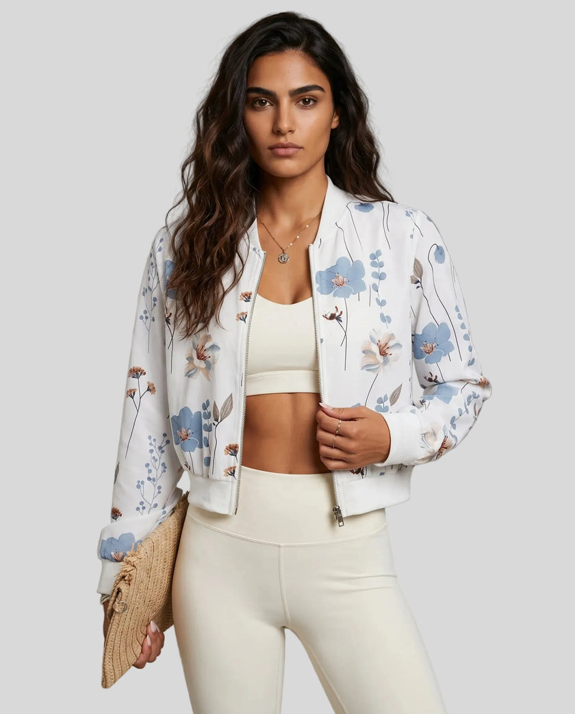 Angled front view of floral zip-up jacket styled with leggings for sporty transitional layering