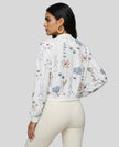Back view of floral lightweight jacket paired with activewear leggings in a relaxed athleisure outfit