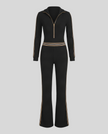 Front view of Monaco Hooded Jumpsuit in Black with zip neckline, contrast waist stripes and wide-leg silhouette