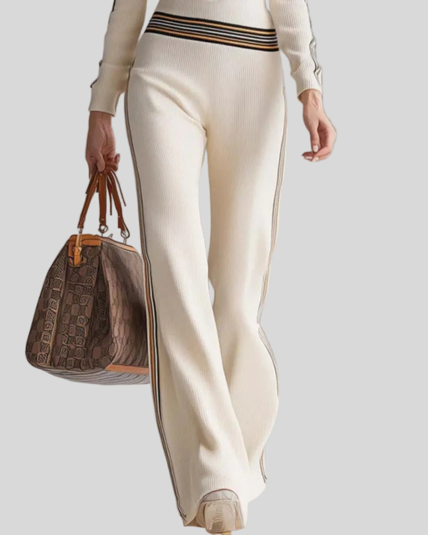 Lower body front view of woman wearing Monaco Hooded Jumpsuit in Milky White with wide legs and contrast side stripes