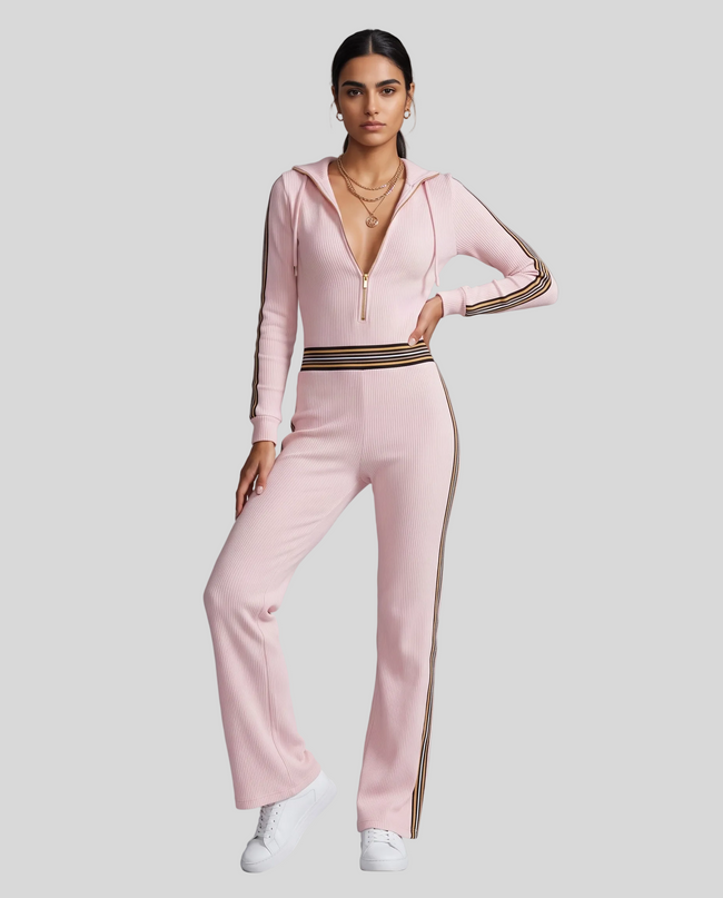 Full body front view of woman styled in Monaco Hooded Jumpsuit in Pink with elegant wide-leg silhouette