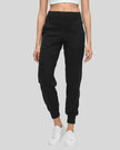 Angled front view of MotionEase Sculpt Jogger Pant in black, showing tapered leg