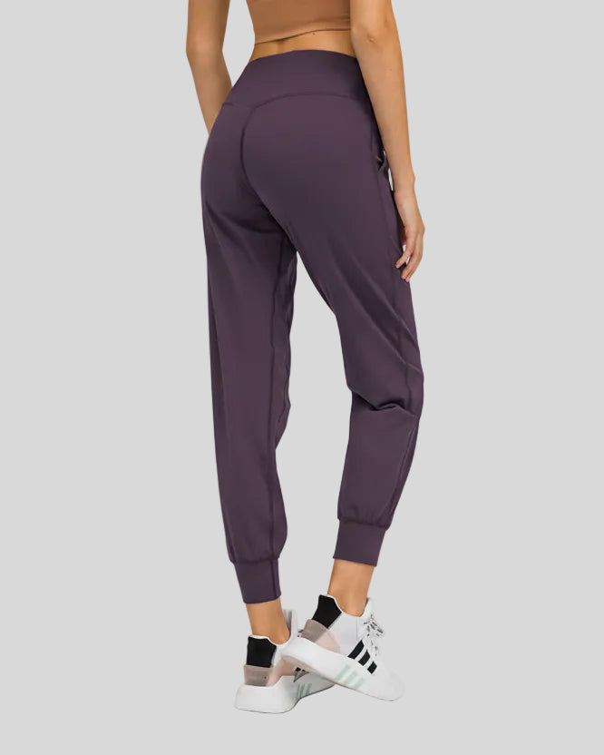 Back view of plum purple Athlesi MotionEase Sculpt Jogger Pant with jogger fit