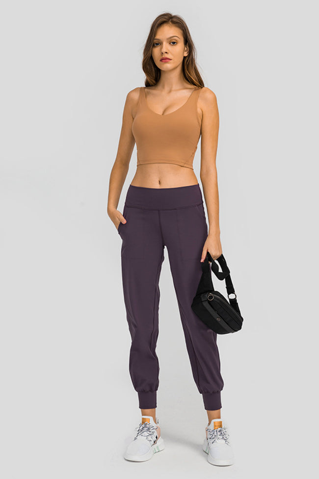 Front view of Athlesi MotionEase Sculpt Jogger Pant in plum purple with wide waistband