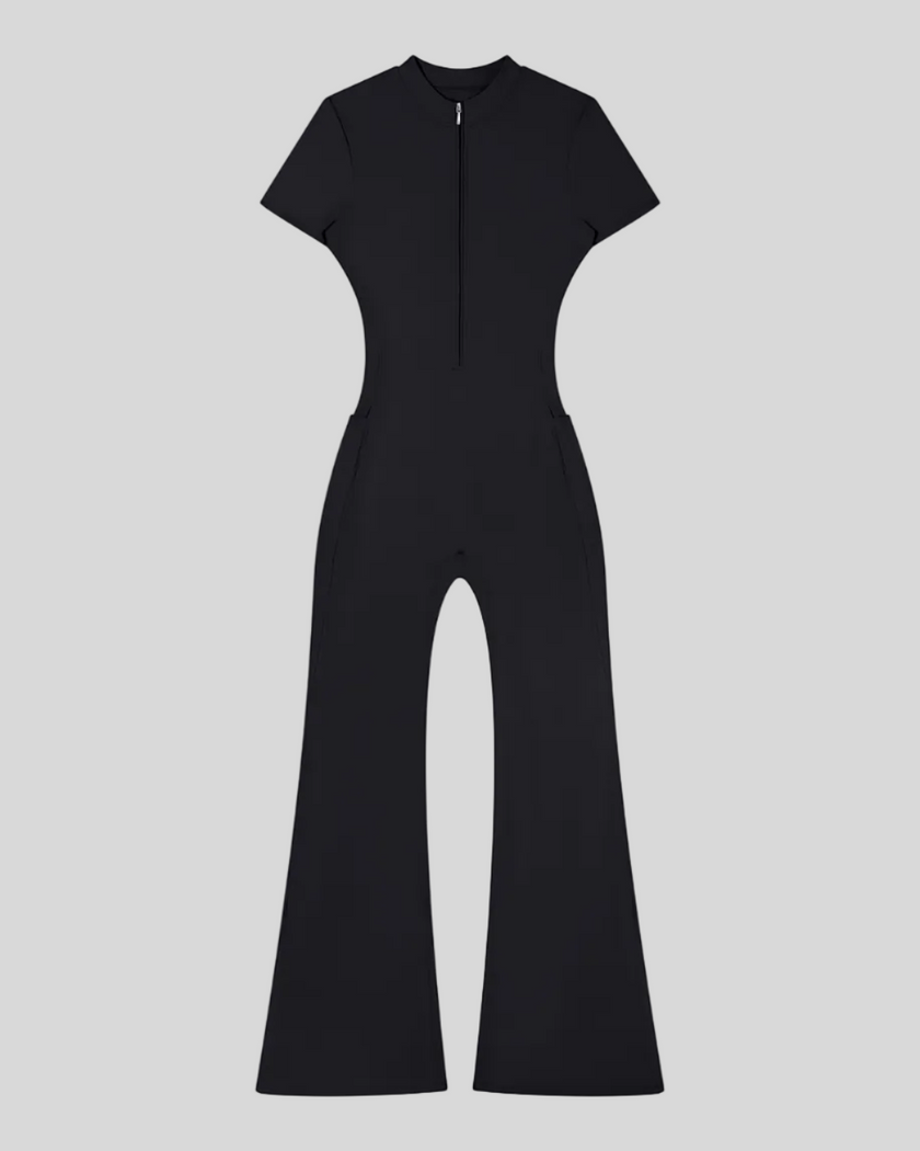 MotionFlow Flared Leg Jumpsuit in Black front view featuring a mock neck, quarter-zip front, and flared legs