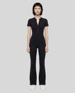 Model wearing the MotionFlow Flared Leg Jumpsuit in Black viewed from the front
