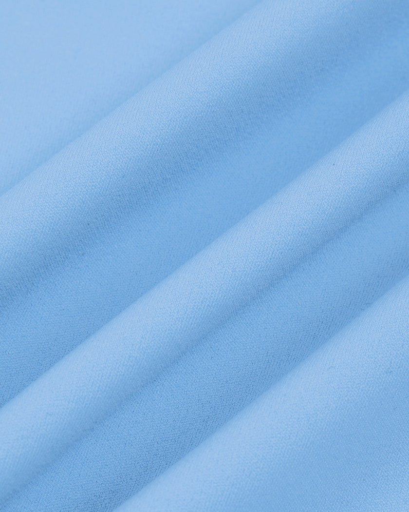 Close-up of the smooth stretch performance fabric used on the MotionFlow Flared Leg Jumpsuit in Blue