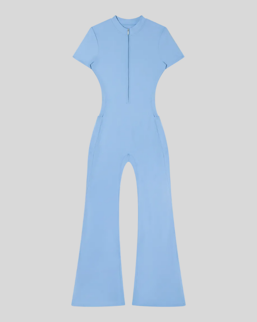 MotionFlow Flared Leg Jumpsuit in Blue front view featuring a mock neck, quarter-zip front, and flared legs