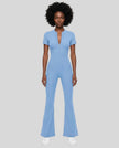Model wearing the MotionFlow Flared Leg Jumpsuit in Blue viewed from the front