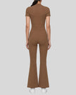 Back view of a model wearing the MotionFlow Flared Leg Jumpsuit in Brown