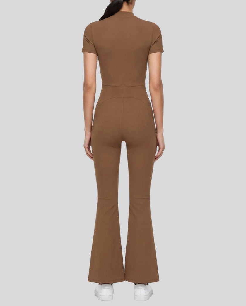 Back view of a model wearing the MotionFlow Flared Leg Jumpsuit in Brown