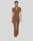 Front angled view of a model wearing the MotionFlow Flared Leg Jumpsuit in Brown