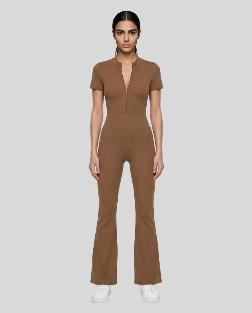 Model wearing the MotionFlow Flared Leg Jumpsuit in Brown viewed from the front