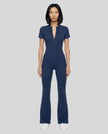 Model wearing the MotionFlow Flared Leg Jumpsuit in Royal Blue viewed from the front