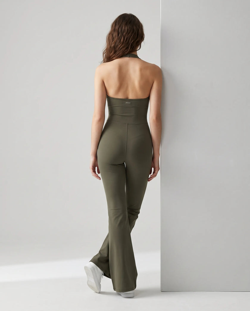 Back view of a model wearing the MotionFlow Halter Jumpsuit in Army Green