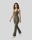 Model wearing the MotionFlow Halter Jumpsuit in Army Green viewed from the front