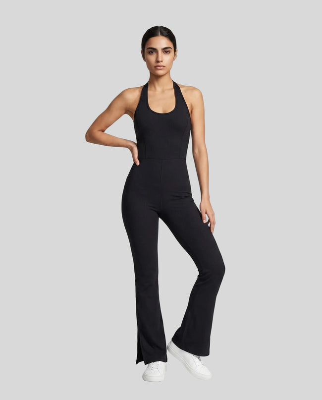 Model wearing the MotionFlow Halter Jumpsuit in Black viewed from the front
