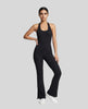 Model wearing the MotionFlow Halter Jumpsuit in Black viewed from the front