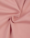 Detailed view of the smooth polyester-spandex fabric and stitching on the MotionFlow Halter Jumpsuit in Pink