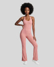 Model wearing the MotionFlow Halter Jumpsuit in Pink viewed from the front