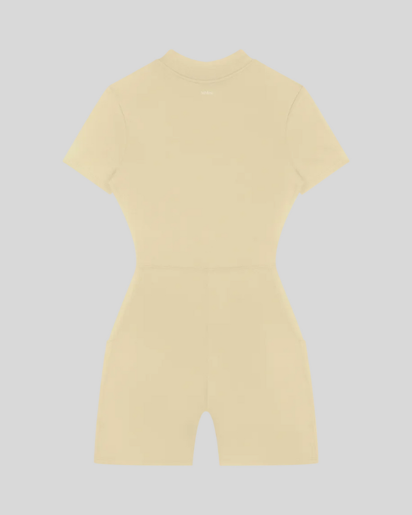MotionFlow Romper in Apricot back view showcasing the sculpted silhouette and bermuda-length shorts