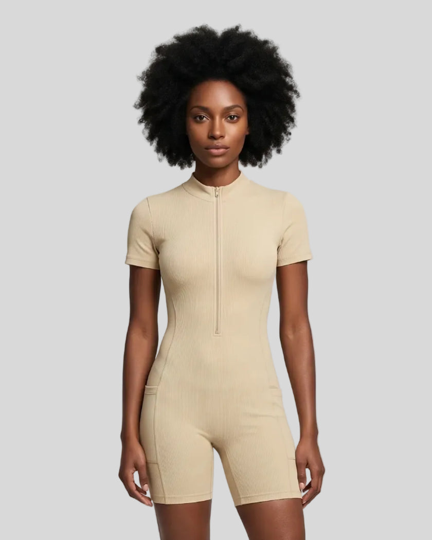 Model wearing the MotionFlow Romper in Apricot viewed from the front