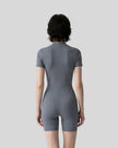 Back view of a model wearing the MotionFlow Romper in Gray Blue