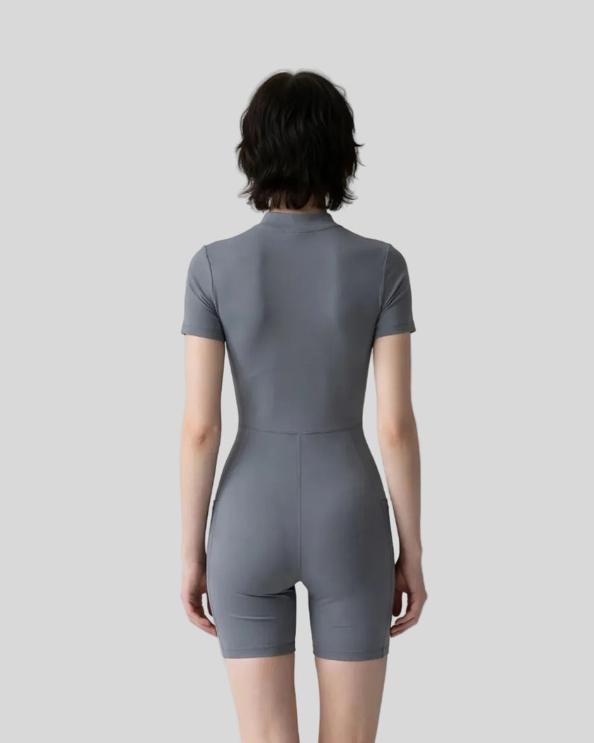 Back view of a model wearing the MotionFlow Romper in Gray Blue