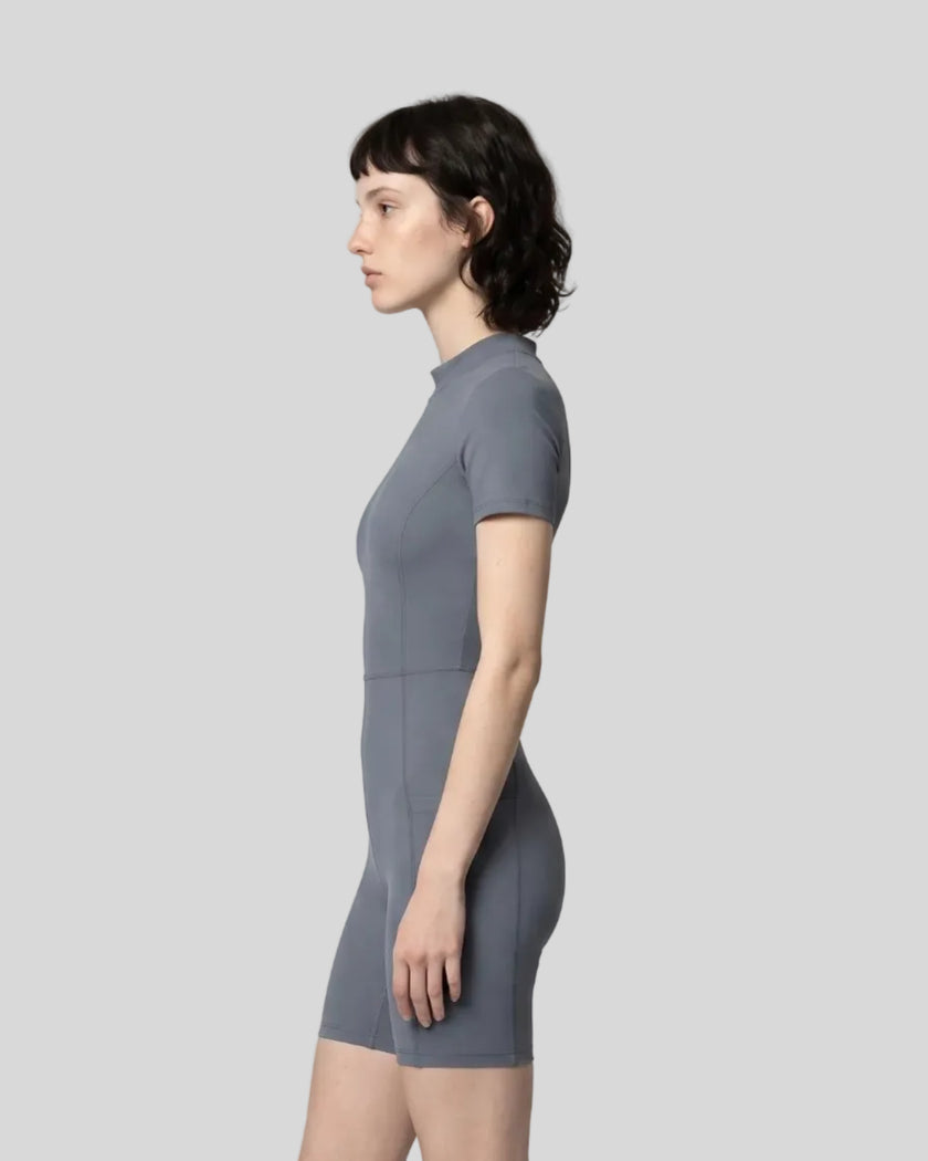 Side view of a model wearing the MotionFlow Romper in Gray Blue