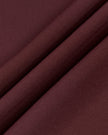 Close-up of the smooth stretch performance fabric used on the MotionFlow Romper in Wine Red