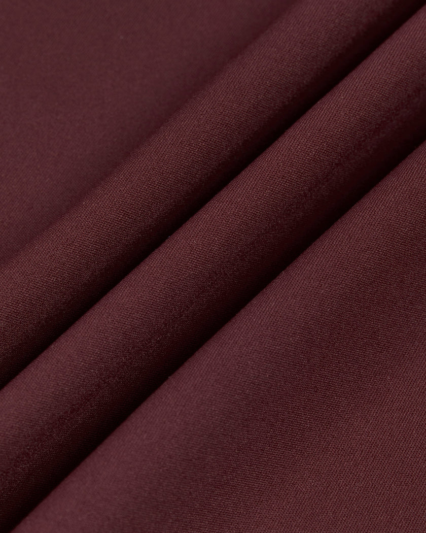Close-up of the smooth stretch performance fabric used on the MotionFlow Romper in Wine Red