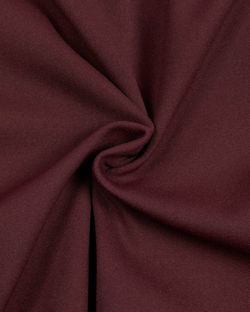 Detailed view of the premium nylon-spandex fabric and stitching on the MotionFlow Romper in Wine Red