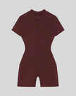 MotionFlow Romper in Wine Red front view featuring a mock neck, quarter-zip front, and bermuda-length shorts