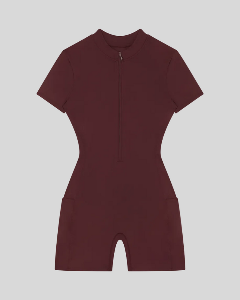 MotionFlow Romper in Wine Red front view featuring a mock neck, quarter-zip front, and bermuda-length shorts