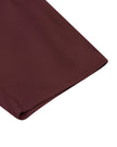 Close-up of the bermuda-length leg hem on the MotionFlow Romper in Wine Red