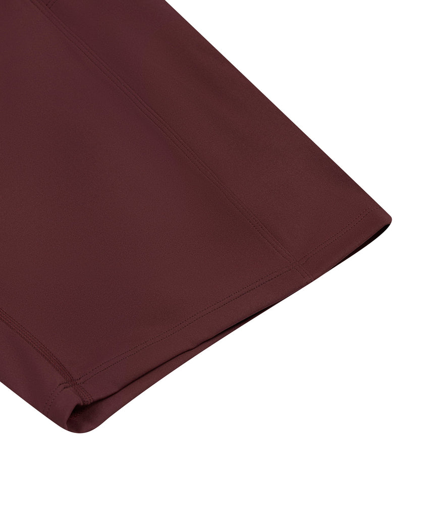 Close-up of the bermuda-length leg hem on the MotionFlow Romper in Wine Red