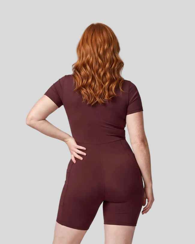 Back view of a model wearing the MotionFlow Romper in Wine Red