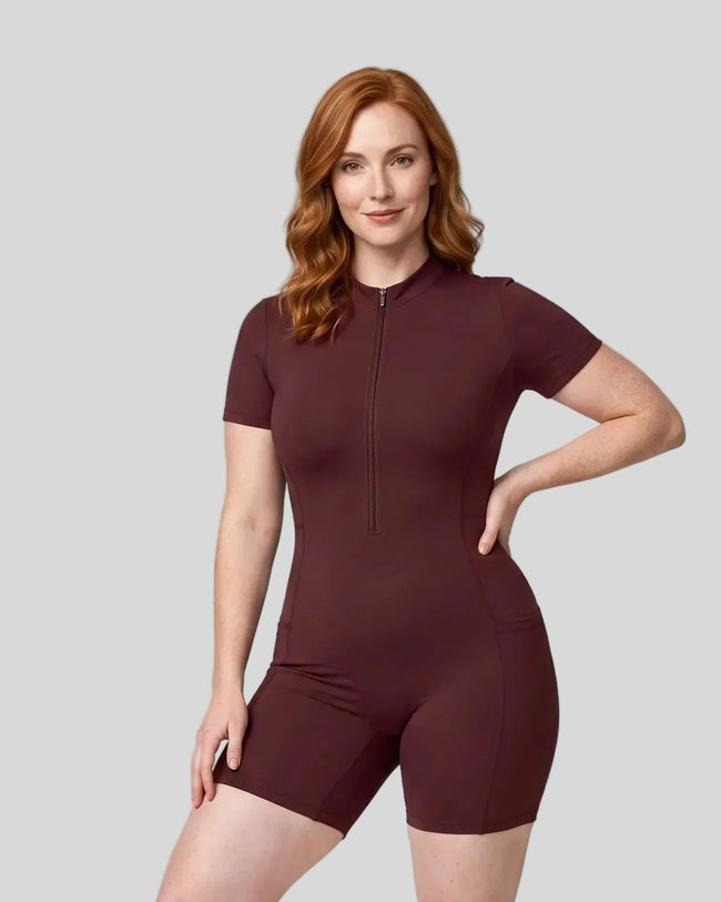 Model wearing the MotionFlow Romper in Wine Red viewed from the front
