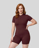Model wearing the MotionFlow Romper in Wine Red viewed from the front