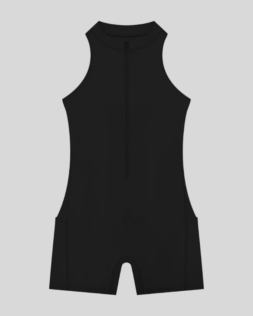 MotionFlow Yoga Romper in Black front view featuring a mock neck, quarter-zip front, and above-the-knee silhouette