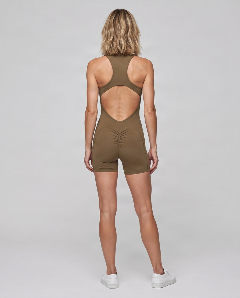 Full body back view of model wearing the MotionFlow Yoga Romper in Coffee.