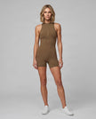 Full body front view of model wearing the MotionFlow Yoga Romper in Coffee.