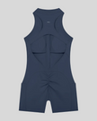 MotionFlow Yoga Romper in Navy Blue back view showcasing the open racerback design and sculpting fit